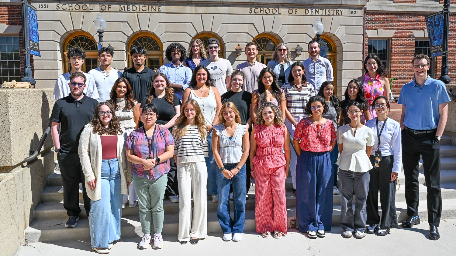 Members of the M.S. in Integrative Neuroscience program stand on the steps outside of the Medical and Dental Building during Fall 2026 Orientation